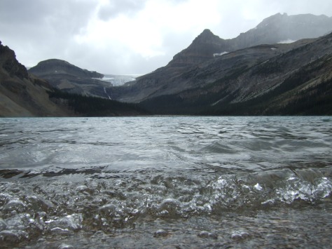Clear lake water with mountains in the background